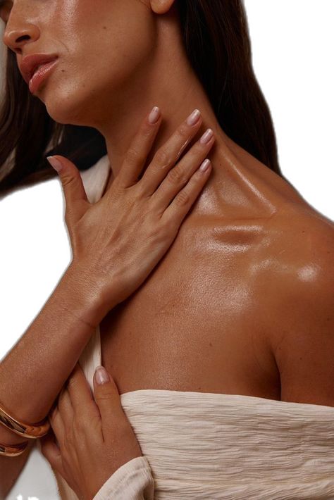 Luxury body lotion applied on hands with open containers and a soft towel in the background