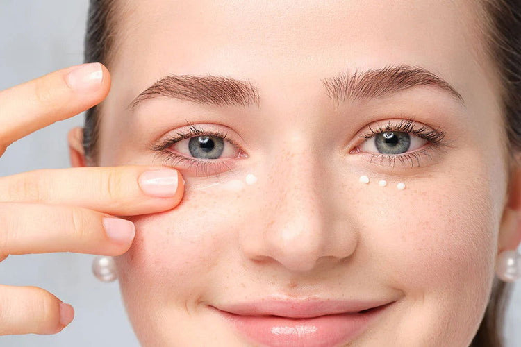 Woman applying hydrating cream for brightening and rejuvenating using eye care products at Pinky Cosmetics