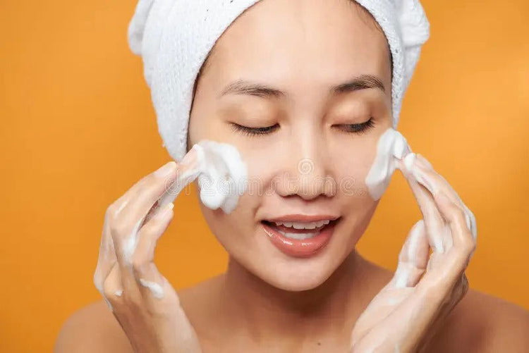 Woman using luxury facial cleansers for a refreshing skincare routine at Pinky Cosmetics