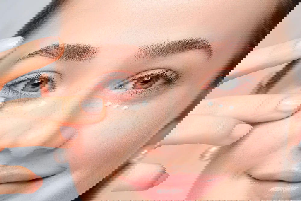 Woman applying hydrating cream for brightening and rejuvenating using eye care products at Pinky Cosmetics