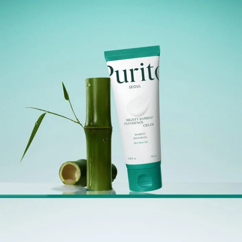 Purito SEOUL Mighty Bamboo Panthenol Cream for hydration beside a bamboo stalk, perfect for deep hydration and skin care.