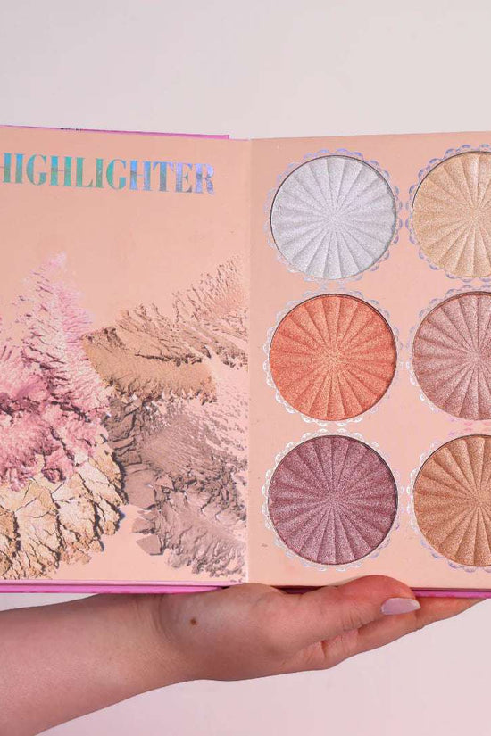 4 in 1 makeup palette open to showcase six shimmery highlighter shades in a vibrant pink book design