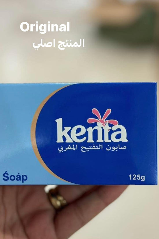 Kenta soap box held in a hand with a blurred background