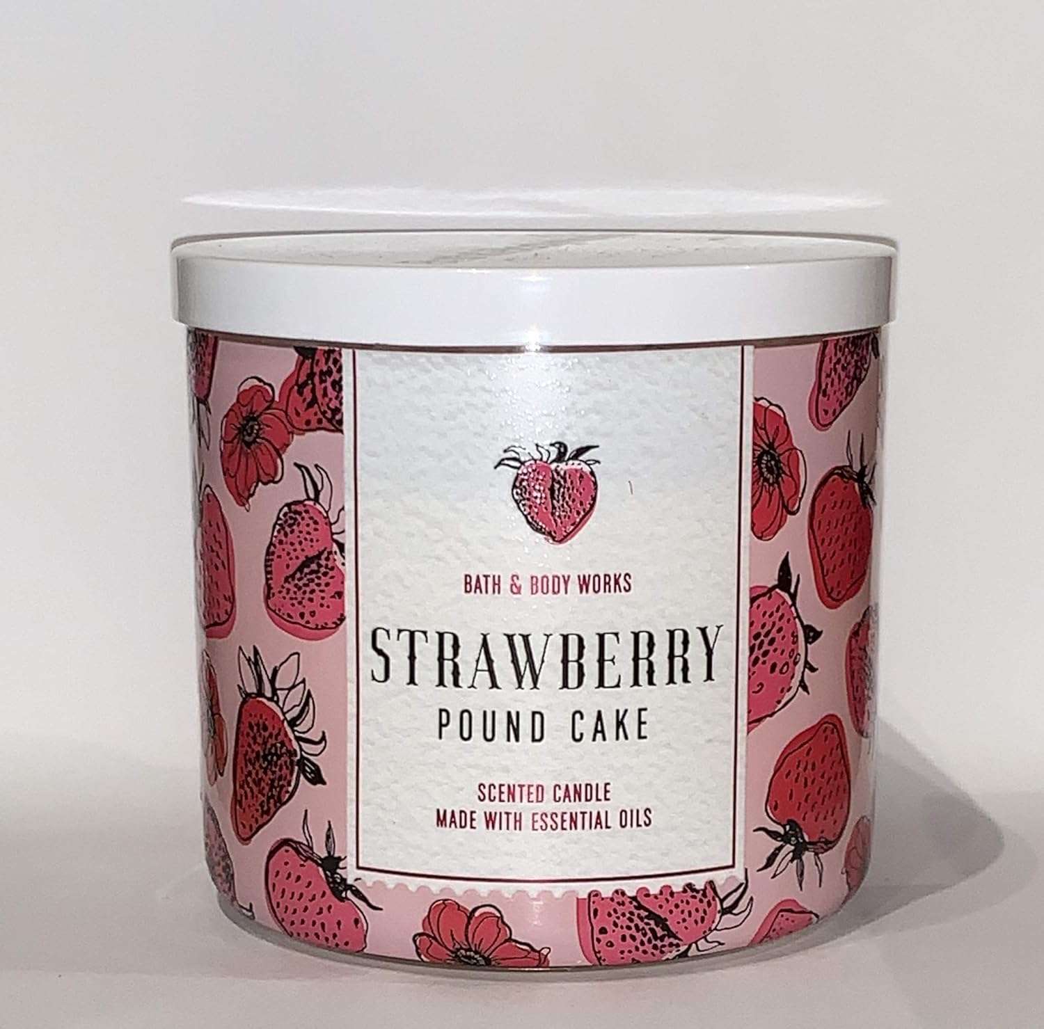 Bath & Body Works Strawberry Pound Cake candle featuring a vibrant strawberry design, made with essential oils for a delightful scent