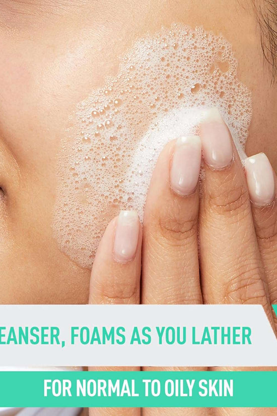 Close-up of a person applying CeraVe foaming facial cleanser normal oily skin on their face with lathering foam.