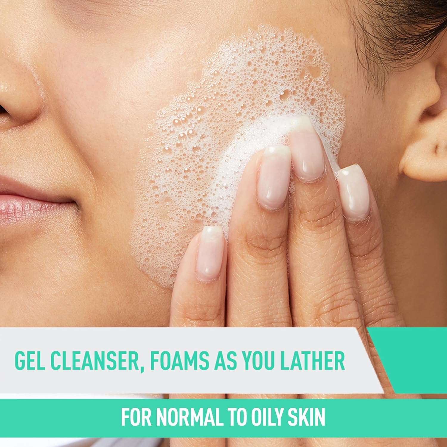 Close-up of a person applying CeraVe foaming facial cleanser normal oily skin on their face with lathering foam.