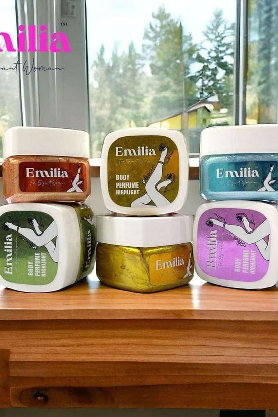 Emilia High Light body perfume collection featuring colorful jars, displayed on a wooden table with natural light
