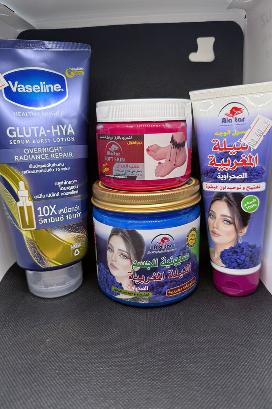 Collection of skincare products including Vaseline and Al Rehab on a gray surface.