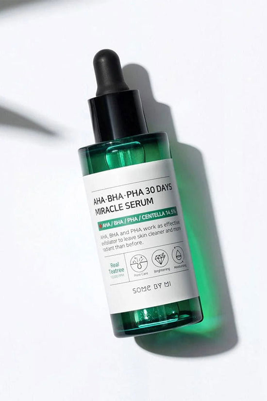 SOME BY MI AHA BHA PHA serum in a sleek green bottle with a dropper, designed for glowing skin and skincare miracles