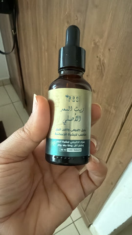 DDS Original Saad Oil 30ml – luxury gold editorial shot on stone pedestal
