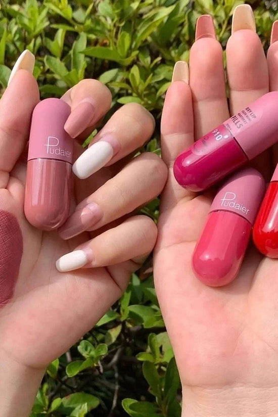 Set of mini capsule matte lipsticks in pink, red, and nude shades held in hands, perfect to buy mini lipstick online UAE