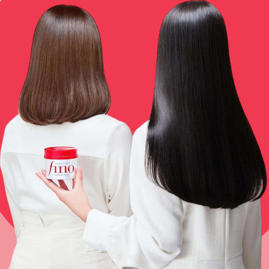 Fino hair mask Japan displayed on a woman's hand with shiny, healthy hair in the background
