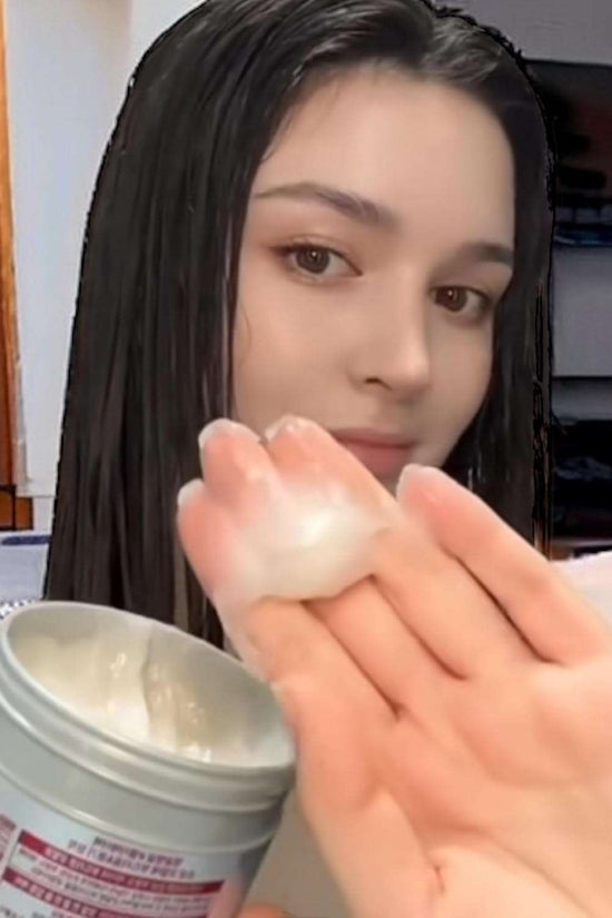 Woman applying Fino hair mask Japan to her hair for deep conditioning and hydration