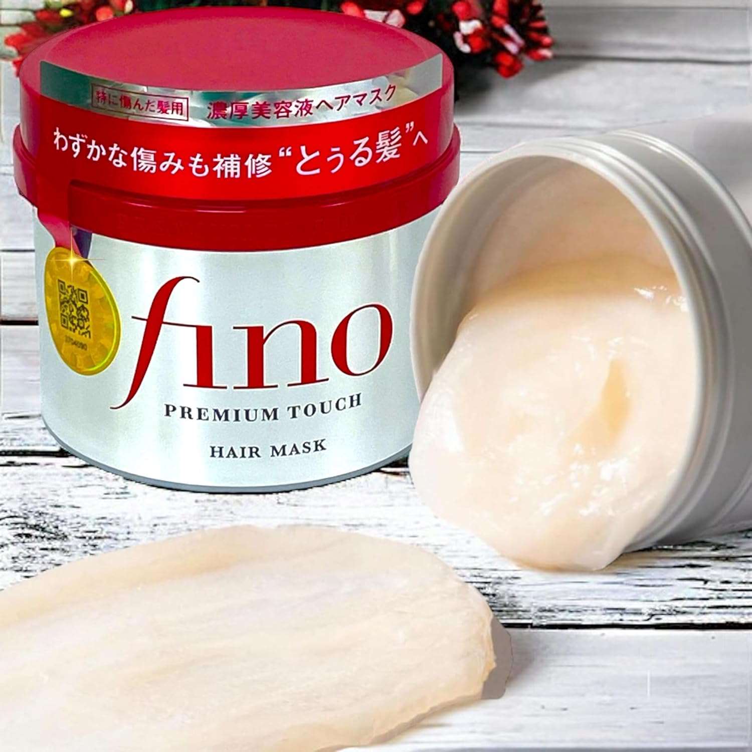 Fino hair mask Japan in a red container with creamy hair treatment spilled on the side