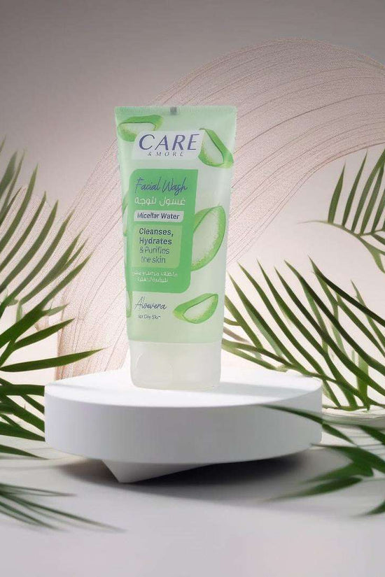 CAREMORE Aloe Vera facial wash for oily skin in a sleek tube with green accents, surrounded by plant leaves for a fresh look
