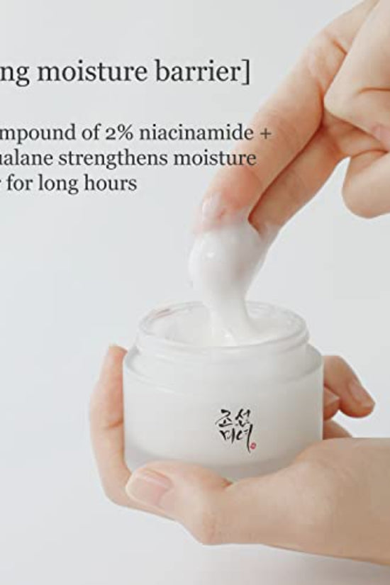 Beauty of Joseon cream in a jar with a hand applying the moisturizer, emphasizes hydration and skincare benefits