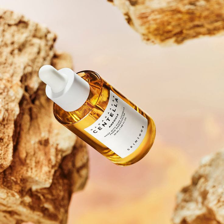 Centella Asiatica skincare serum in a glass bottle against a natural background for glowing skin
