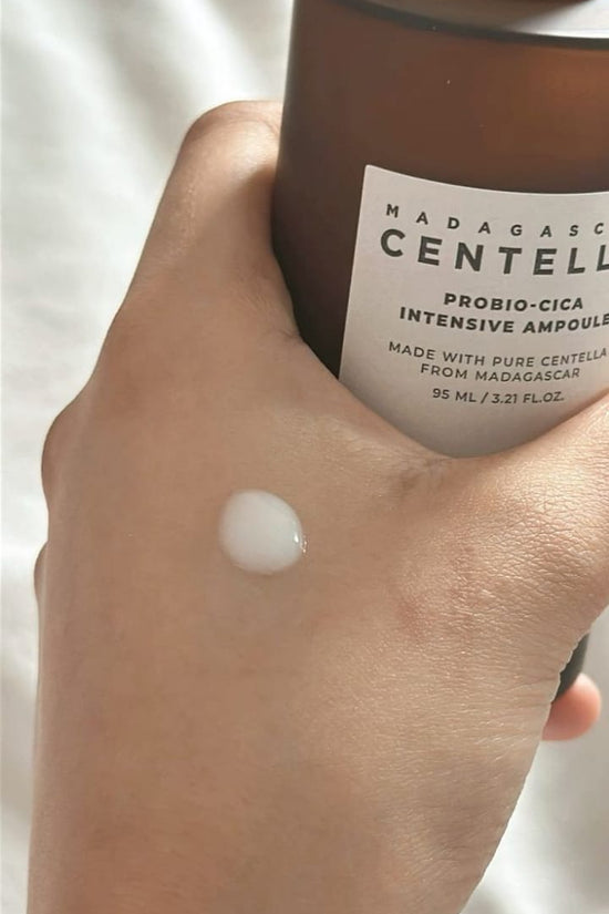 SKIN1004 Centella ampoule for glowing skin applied to a hand with the bottle displayed
