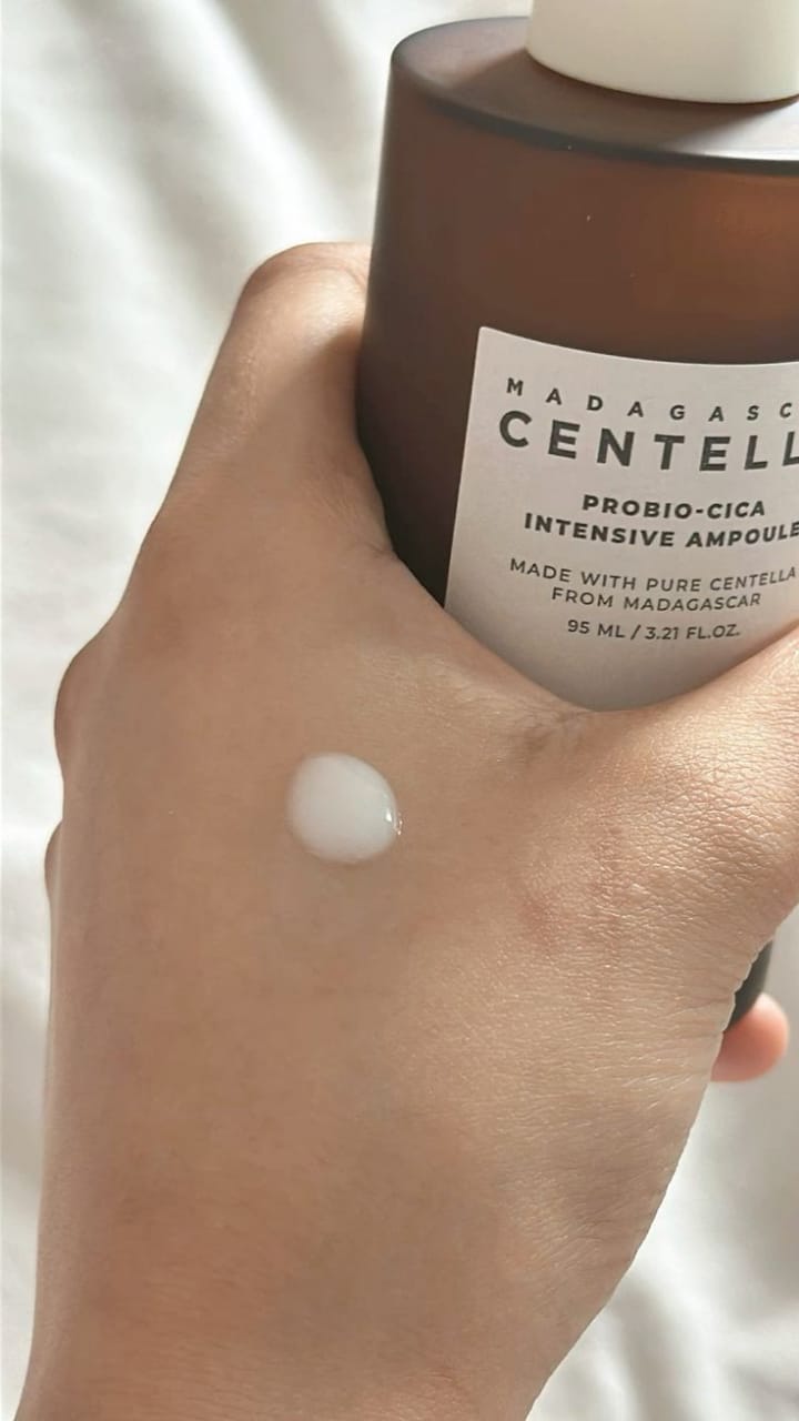 SKIN1004 Centella ampoule for glowing skin applied to a hand with the bottle displayed