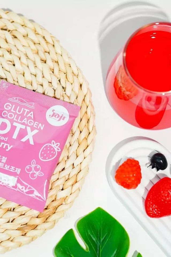 Pinky Cosmetics Gluta Collagen detox supplement in a pink package with berry flavor on a woven tray