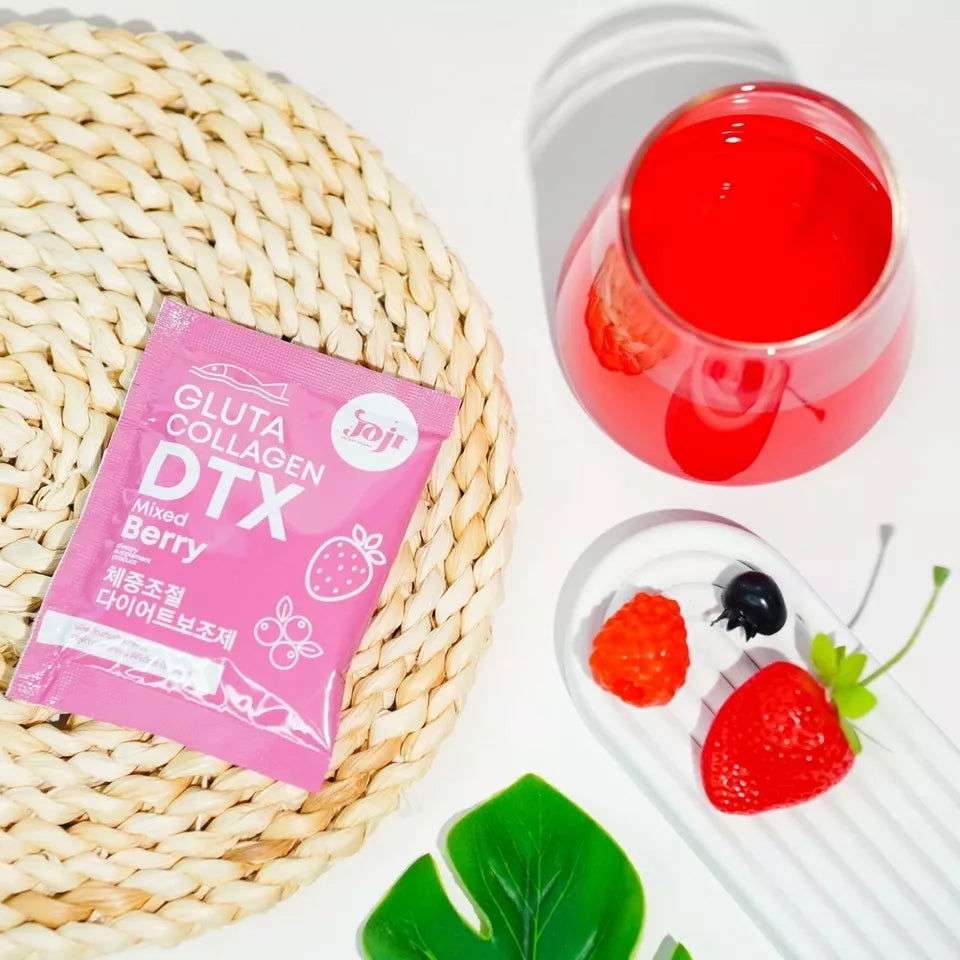 Pinky Cosmetics Gluta Collagen detox supplement in a pink package with berry flavor on a woven tray